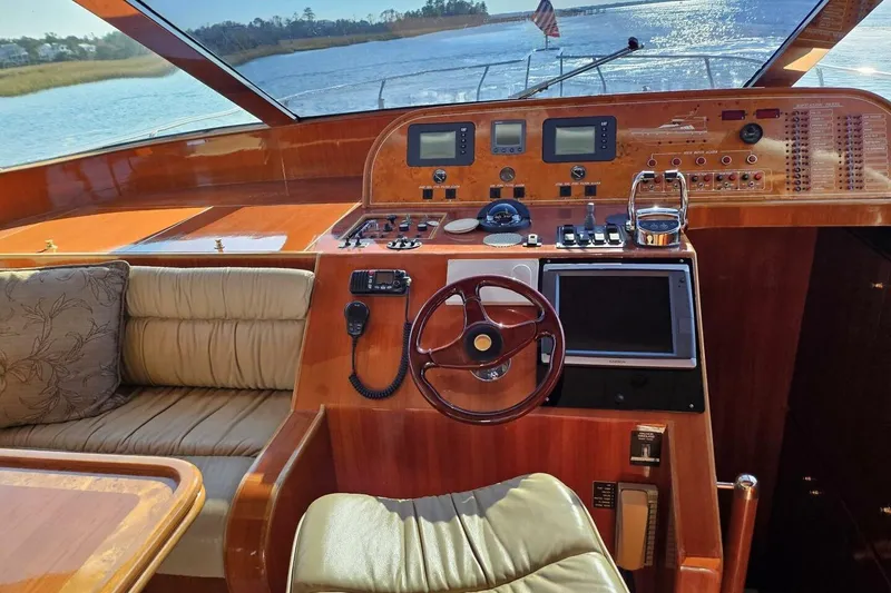 Slide: The Image of 2003 Johnson FLY yacht cockpit with wooden dashboard and modern navigation equipment. - 20