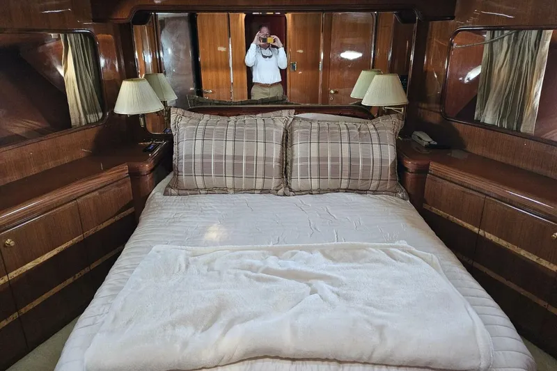 Slide: The Image of Luxurious bedroom interior on a 2003 Johnson FLY yacht with elegant wood finishes. - 22