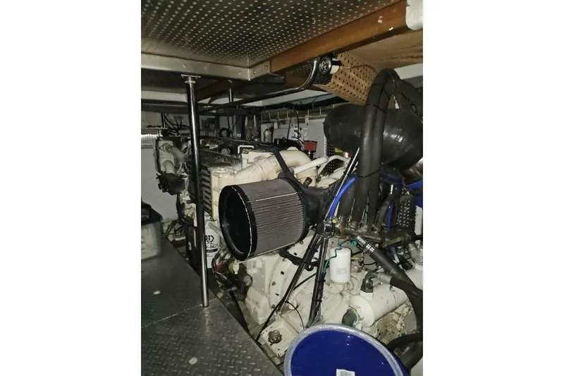 Slide: The Image of Engine room of a 2003 Johnson FLY model, showcasing mechanical components and piping. - 28