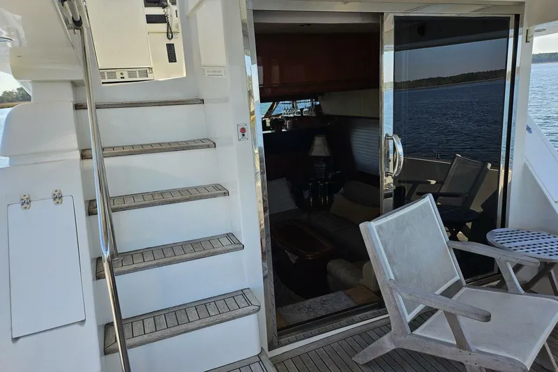 Slide: The Image of Staircase and seating area on 2003 Johnson FLY yacht with ocean view. - 7