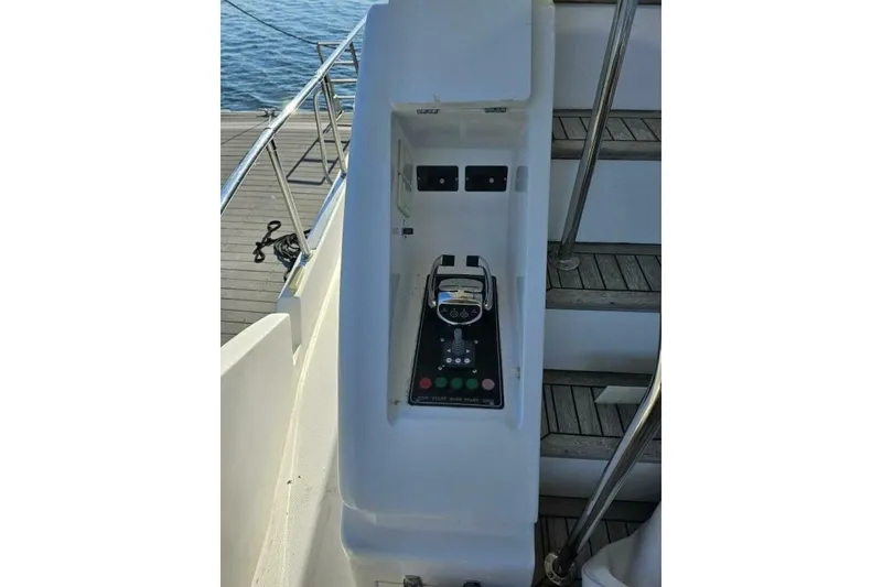 Slide: The Image of Control panel on a 2003 Johnson FLY boat, near wooden steps and railing. - 9