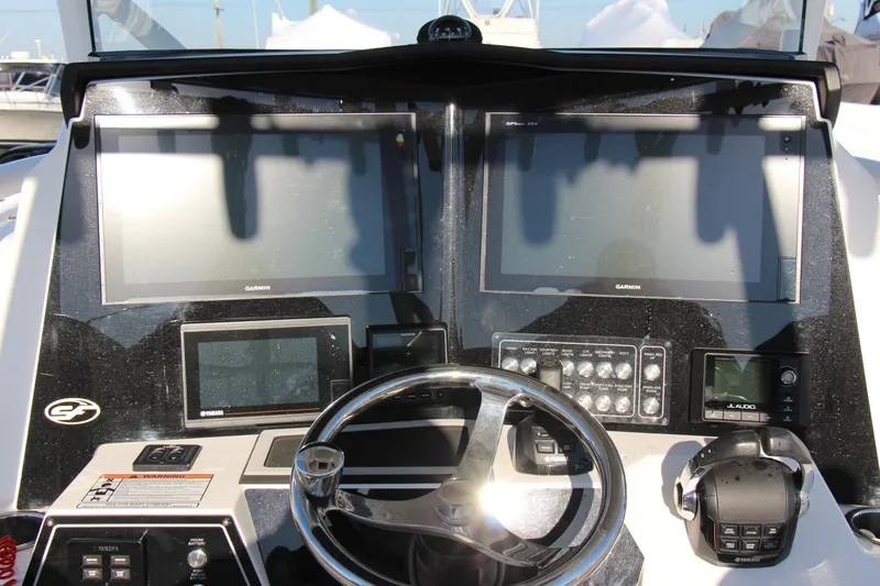 Slide: The Image of Control panel of 2020 Sea Fox 328 Commander boat with Garmin displays and steering wheel. - 10