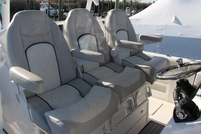Slide: The Image of Luxurious seating on 2020 Sea Fox 328 Commander boat with steering wheel. - 11