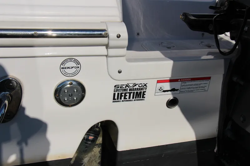 Slide: The Image of 2020 Sea Fox 328 Commander boat with lifetime warranty label and safety warning. - 5