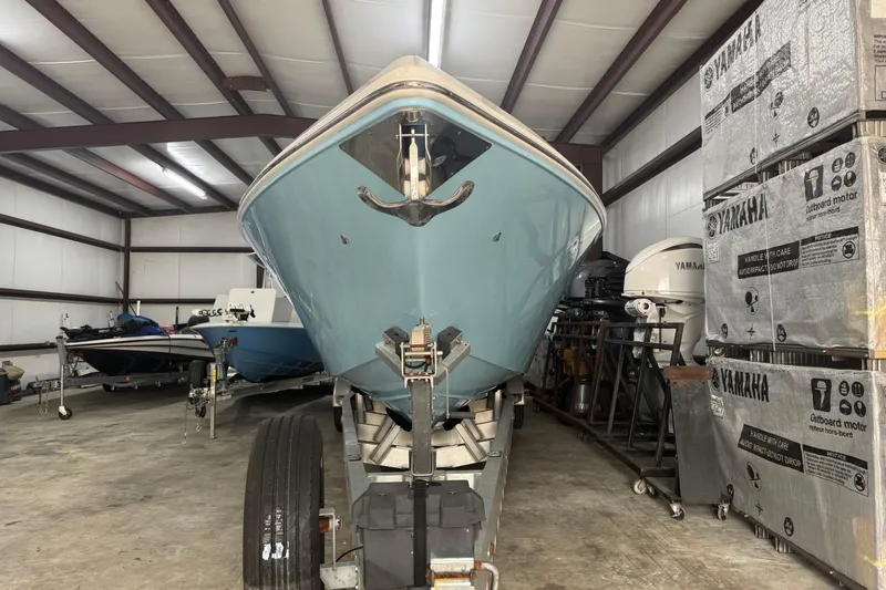 Slide: The Image of 2019 Fountain 38 Center Console boat in storage, surrounded by Yamaha equipment. - 14