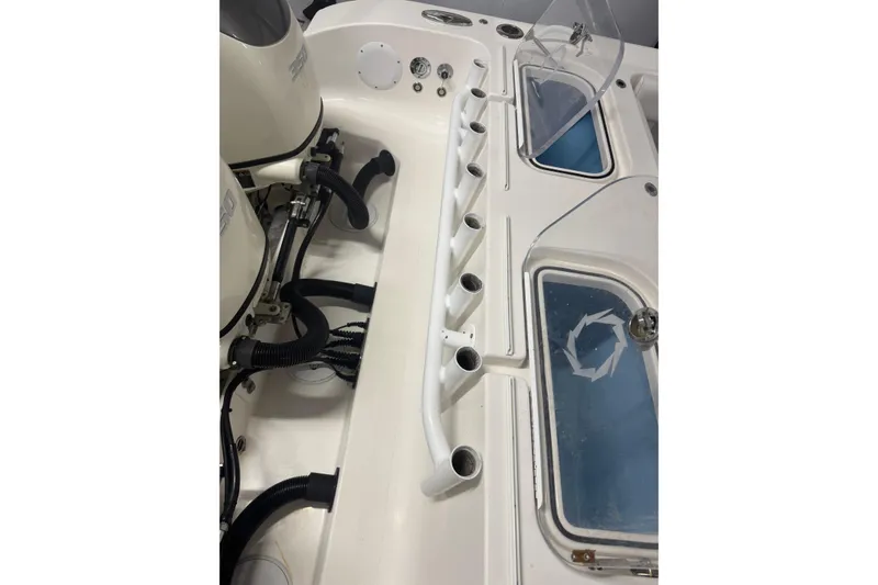 Slide: The Image of 2019 Fountain 38 Center Console boat interior with rod holders and engine components. - 16