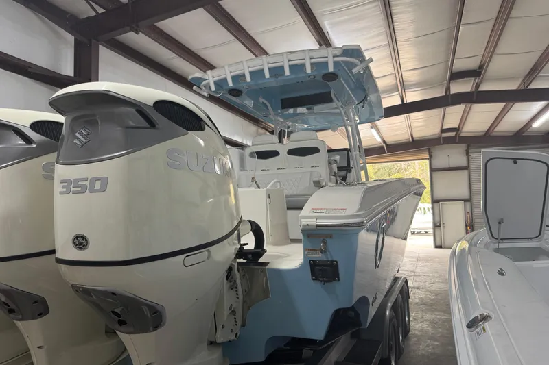 Slide: The Image of 2019 Fountain 38 Center Console boat with Suzuki 350 engines in a storage facility. - 17