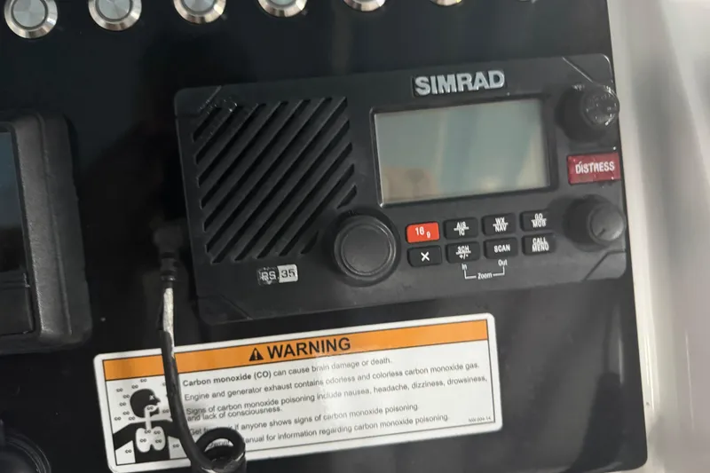 Slide: The Image of Simrad marine radio on 2019 Fountain 38 Center Console with warning label. - 19