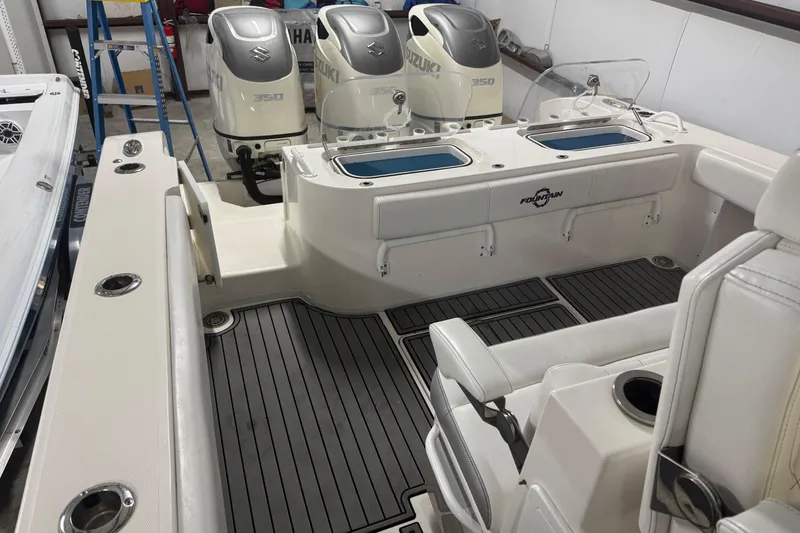 Slide: The Image of 2019 Fountain 38 Center Console boat with Suzuki engines, featuring spacious deck and seating. - 26