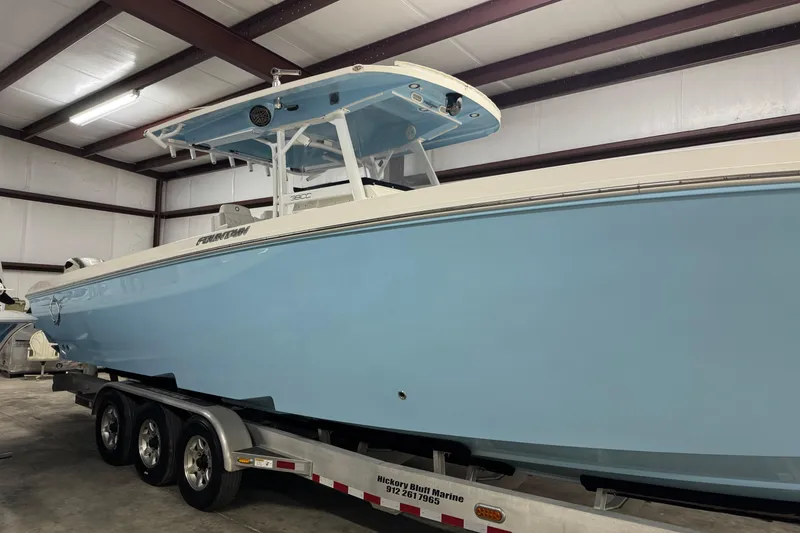 Slide: The Image of 2019 Fountain 38 Center Console boat in storage, light blue hull on trailer. - 3