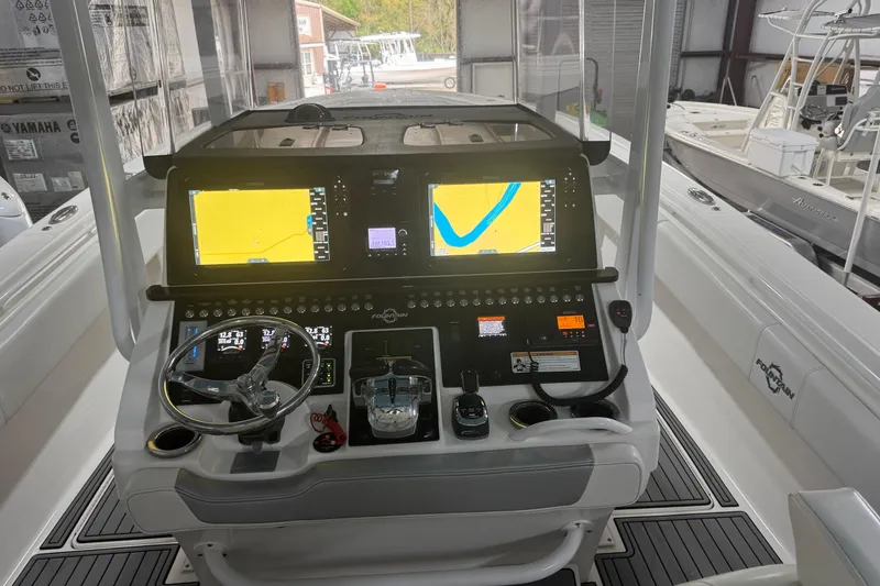 Slide: The Image of 2019 Fountain 38 Center Console boat dashboard with dual navigation screens and controls. - 31