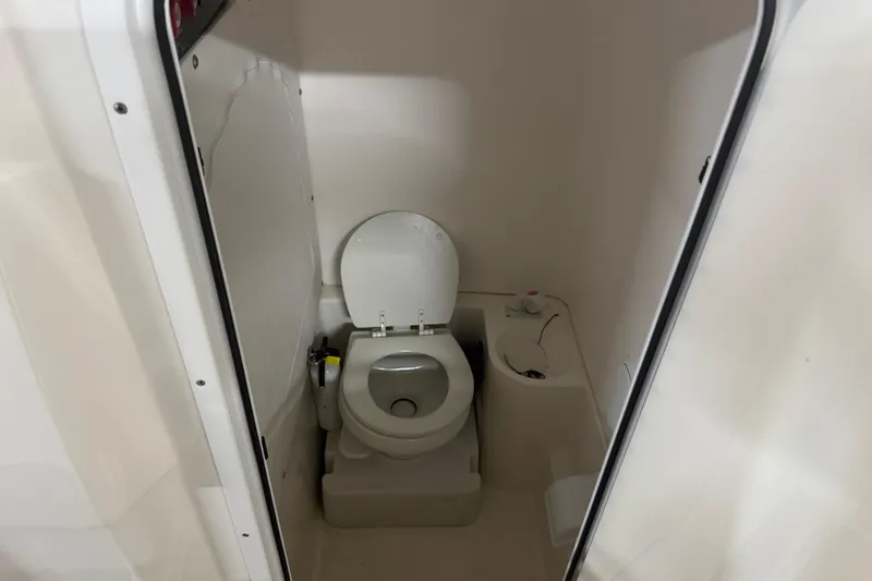Slide: The Image of 2019 Fountain 38 Center Console boat bathroom interior with toilet. - 35