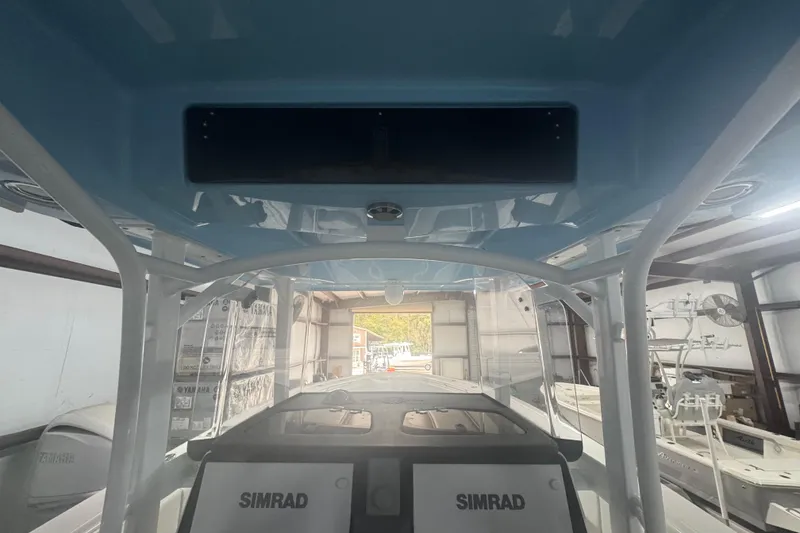 Slide: The Image of 2019 Fountain 38 Center Console boat interior with Simrad electronics in a storage facility. - 41