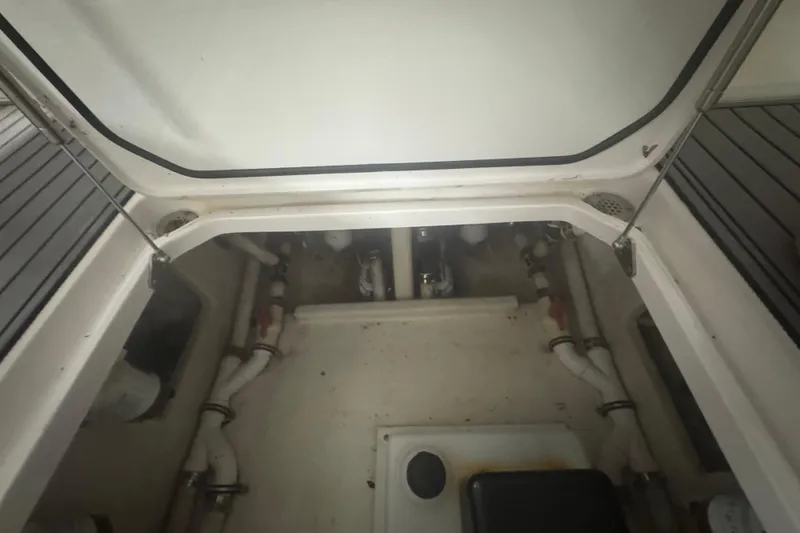 Slide: The Image of 2019 Fountain 38 Center Console boat interior, showcasing plumbing and storage compartment. - 43