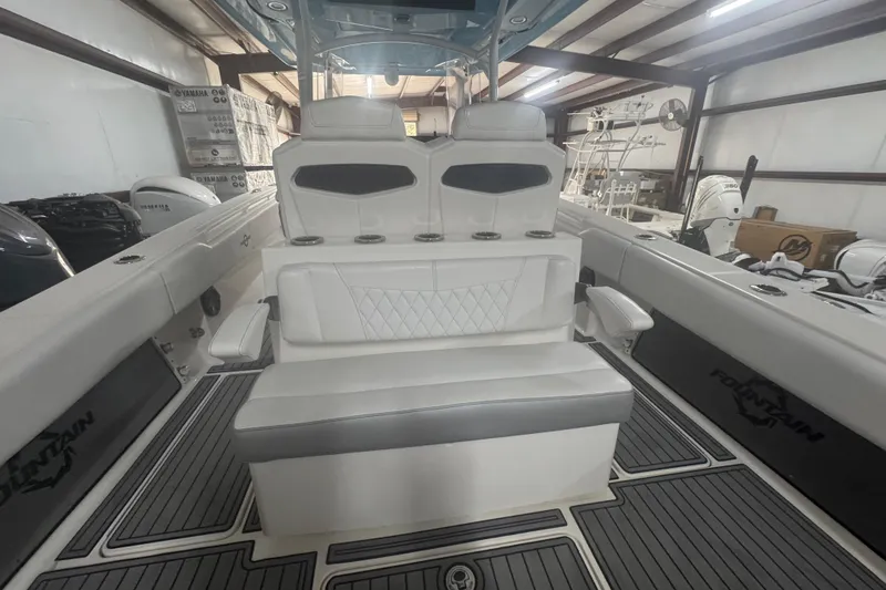 Slide: The Image of 2019 Fountain 38 Center Console boat interior with cushioned seating and modern design. - 45