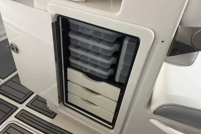 Slide: The Image of Storage compartment with tackle boxes in a 2019 Fountain 38 Center Console boat. - 49