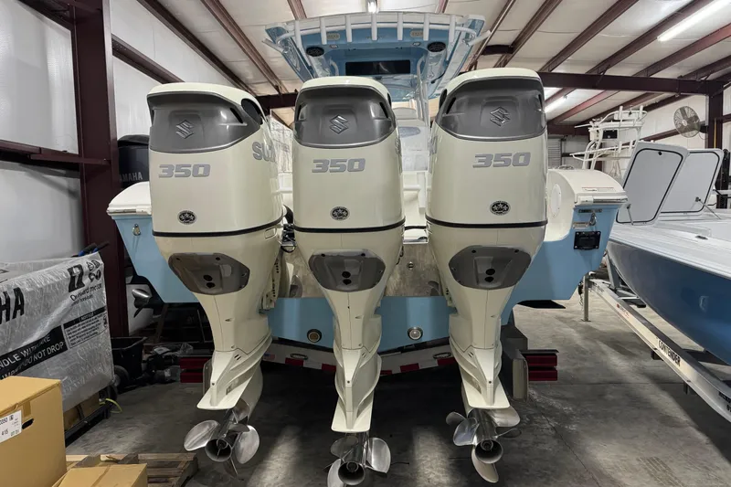 Slide: The Image of 2019 Fountain 38 Center Console with triple Suzuki 350 outboard engines in a storage facility. - 5