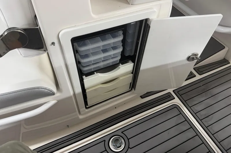 Slide: The Image of Open storage compartment on 2019 Fountain 38 Center Console boat with organized trays. - 50