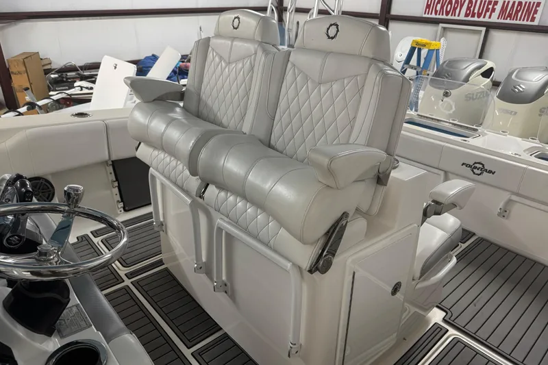 Slide: The Image of 2019 Fountain 38 Center Console boat interior with luxurious seating and steering wheel. - 52