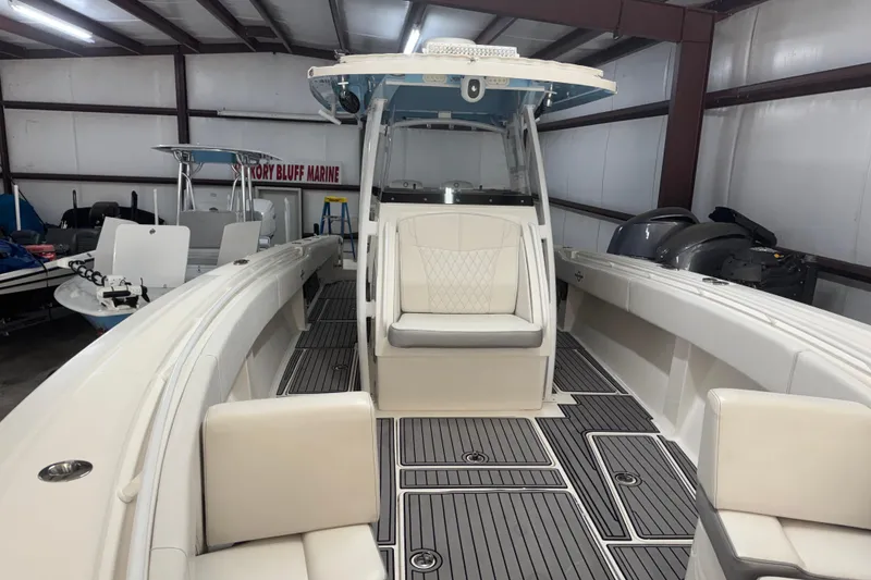 Slide: The Image of 2019 Fountain 38 Center Console boat in showroom, featuring spacious seating and modern design. - 58