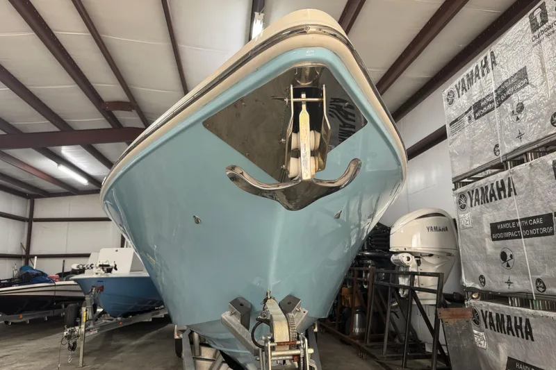Slide: The Image of 2019 Fountain 38 Center Console boat in storage, featuring a sleek blue hull. - 6