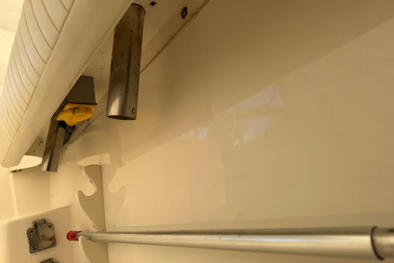 Slide: The Image of 2008 Henriques 30 Express boat interior with rod holders and storage compartment. - 10