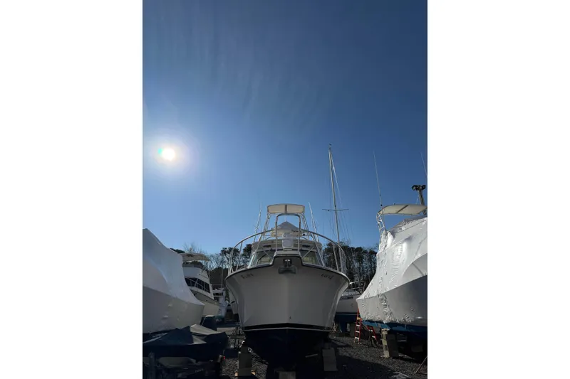 Slide: The Image of 2008 Henriques 30 Express boat under clear blue sky in a marina. - 100