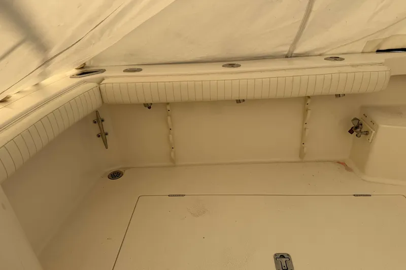 Slide: The Image of 2008 Henriques 30 Express boat interior with cushioned seating and storage compartments. - 14