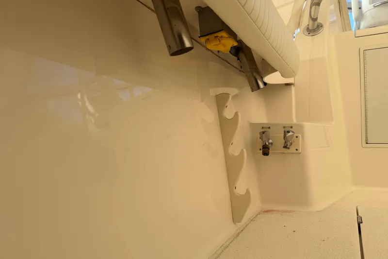 Slide: The Image of 2008 Henriques 30 Express boat interior with rod holders and utility fixtures. - 15