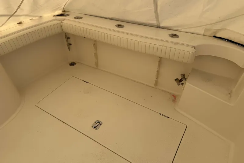Slide: The Image of 2008 Henriques 30 Express boat interior with seating and storage compartment. - 16