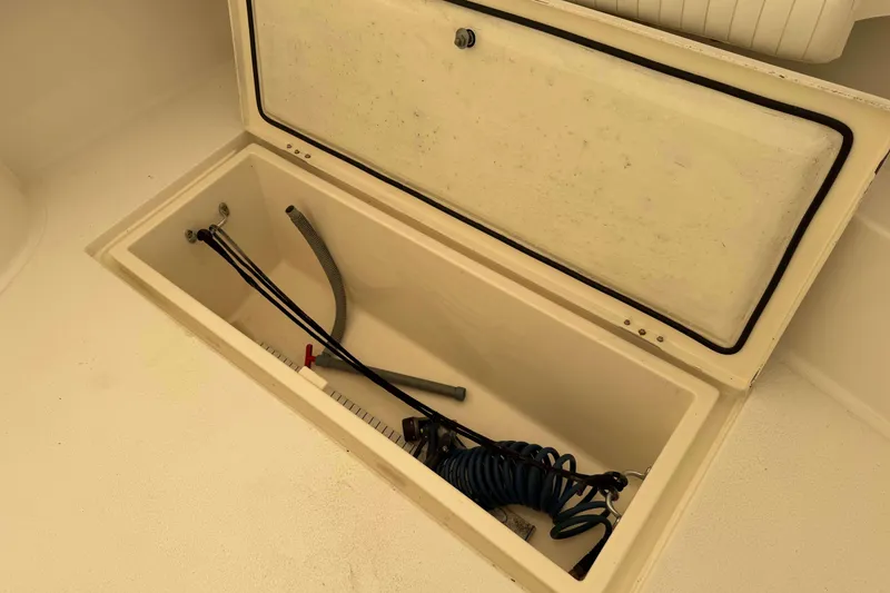 Slide: The Image of Storage compartment on a 2008 Henriques 30 Express boat with hoses inside. - 17