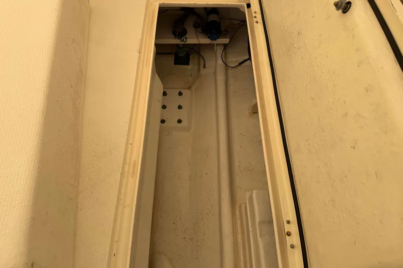 Slide: The Image of Interior compartment of a 2008 Henriques 30 Express boat, showing storage space. - 18