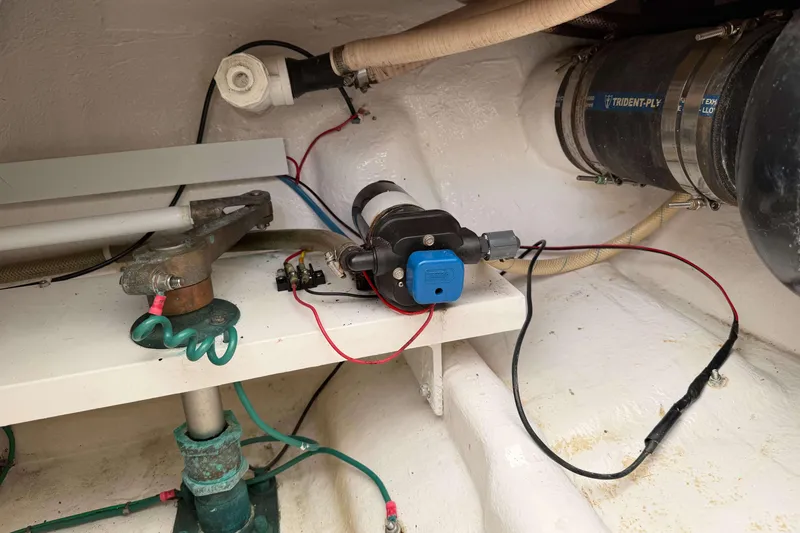 Slide: The Image of 2008 Henriques 30 Express boat interior showing mechanical components and wiring setup. - 19