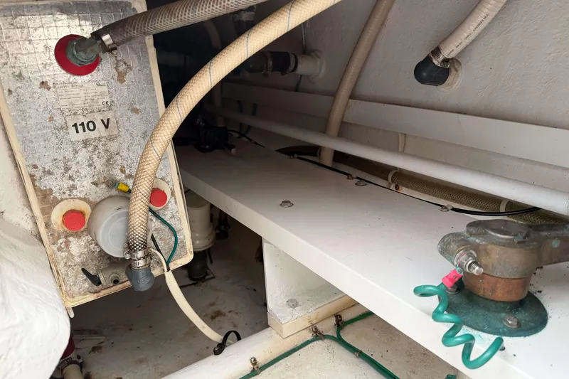 Slide: The Image of Engine compartment of a 2008 Henriques 30 Express boat, showing electrical and plumbing components. - 20