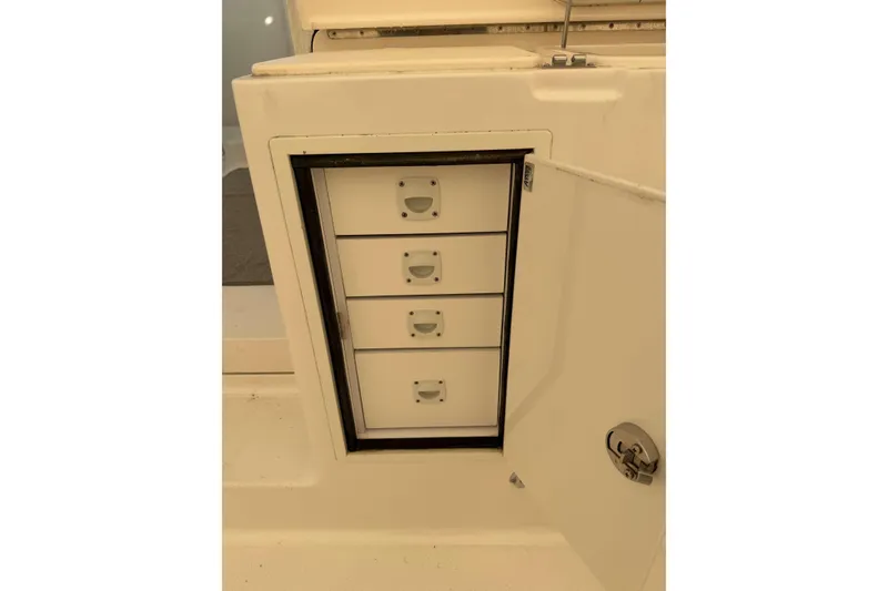 Slide: The Image of Storage drawers on a 2008 Henriques 30 Express boat, open compartment view. - 24