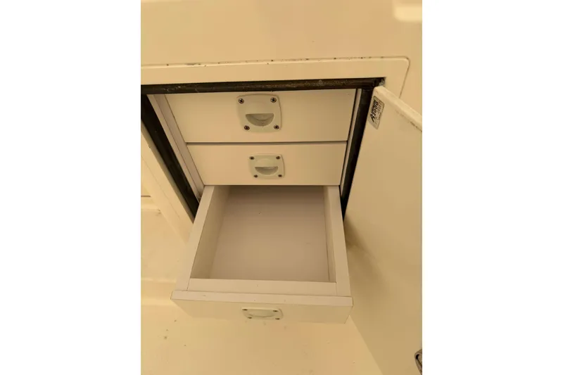 Slide: The Image of Open storage drawers on a 2008 Henriques 30 Express boat. - 25