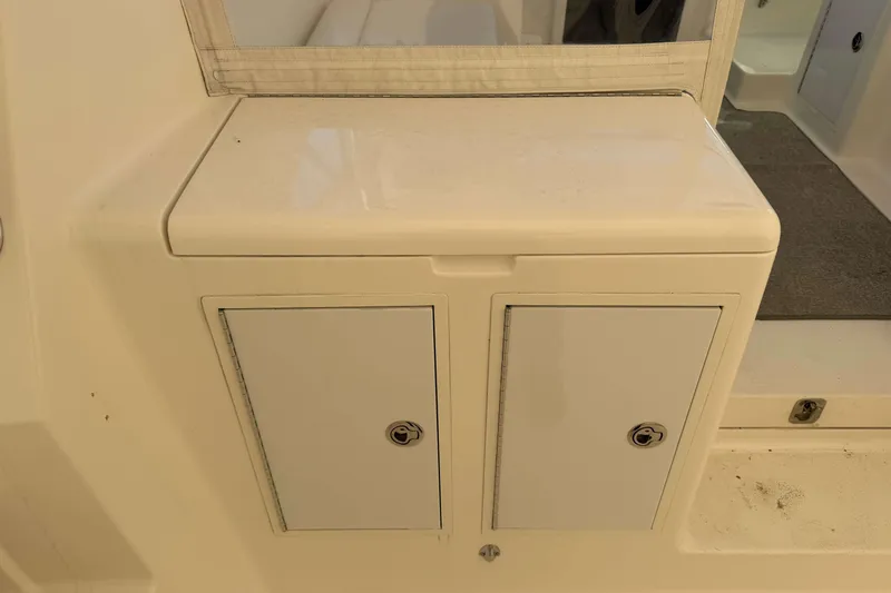 Slide: The Image of 2008 Henriques 30 Express boat interior storage compartment with dual lockable doors. - 26