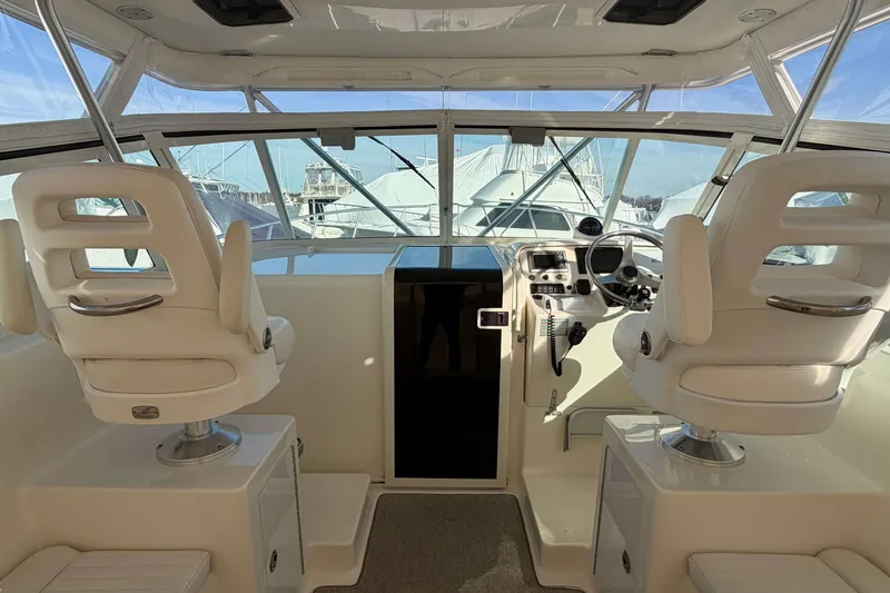 Slide: The Image of 2008 Henriques 30 Express boat interior with helm and white captain chairs. - 31