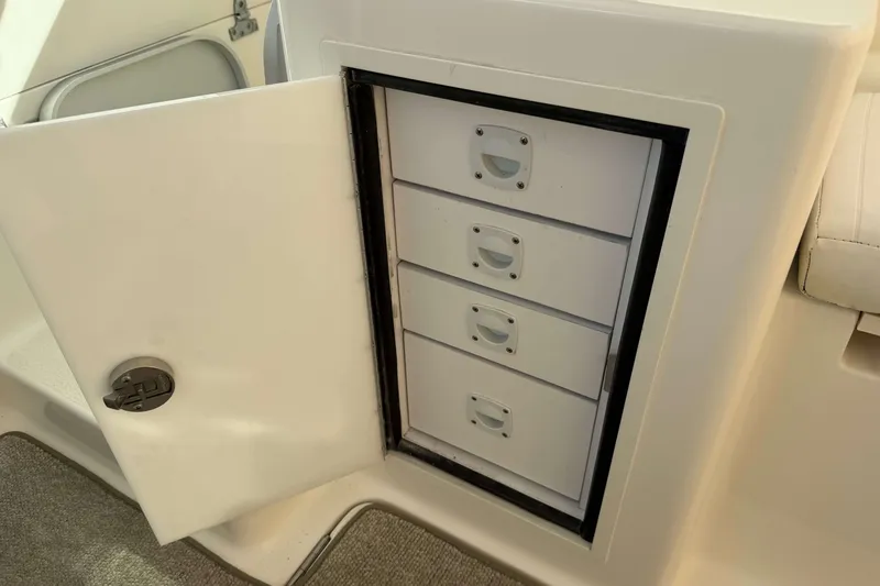 Slide: The Image of Open storage compartment with drawers on a 2008 Henriques 30 Express boat. - 33