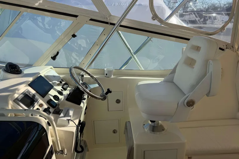 Slide: The Image of 2008 Henriques 30 Express boat interior with steering wheel and captain's chair. - 38