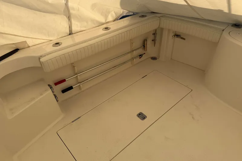 Slide: The Image of 2008 Henriques 30 Express boat interior with storage compartments and fishing rod holders. - 4