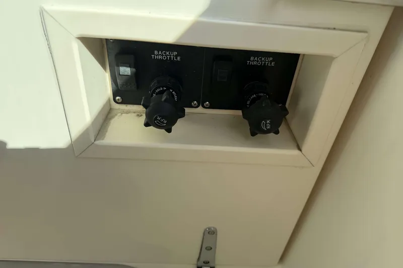 Slide: The Image of Backup throttle controls on a 2008 Henriques 30 Express boat dashboard. - 42