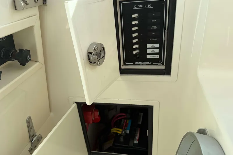 Slide: The Image of 2008 Henriques 30 Express electrical panel with open compartments and switches. - 43