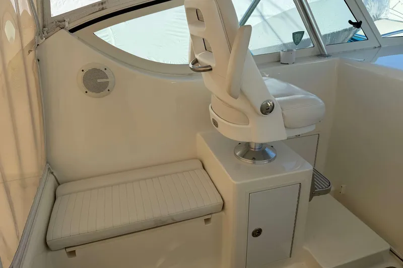 Slide: The Image of 2008 Henriques 30 Express boat interior with white seating and helm station. - 44
