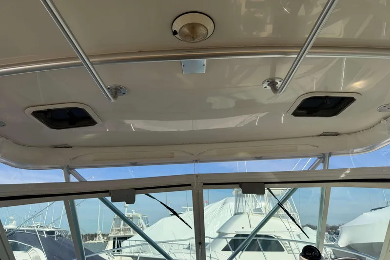 Slide: The Image of 2008 Henriques 30 Express boat interior with roof hatches and marina view. - 47