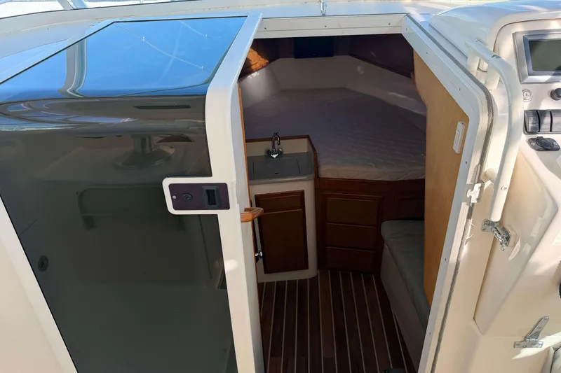 Slide: The Image of 2008 Henriques 30 Express cabin interior with bed, sink, and wooden cabinetry. - 49