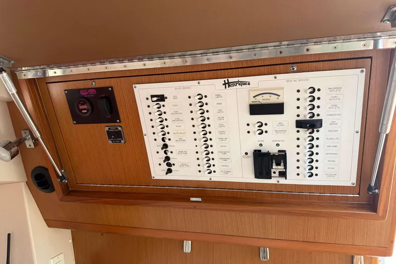 Slide: The Image of Electrical panel of a 2008 Henriques 30 Express boat, featuring various switches and controls. - 53
