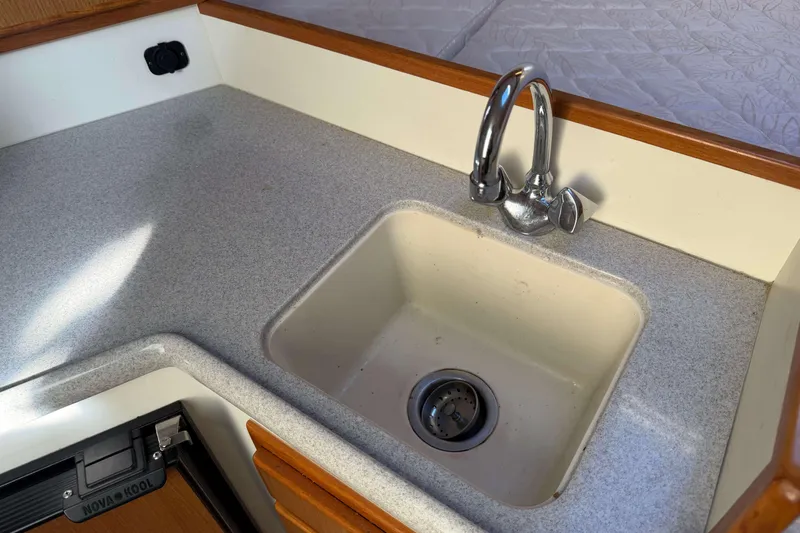 Slide: The Image of 2008 Henriques 30 Express boat kitchen sink with chrome faucet and countertop. - 57