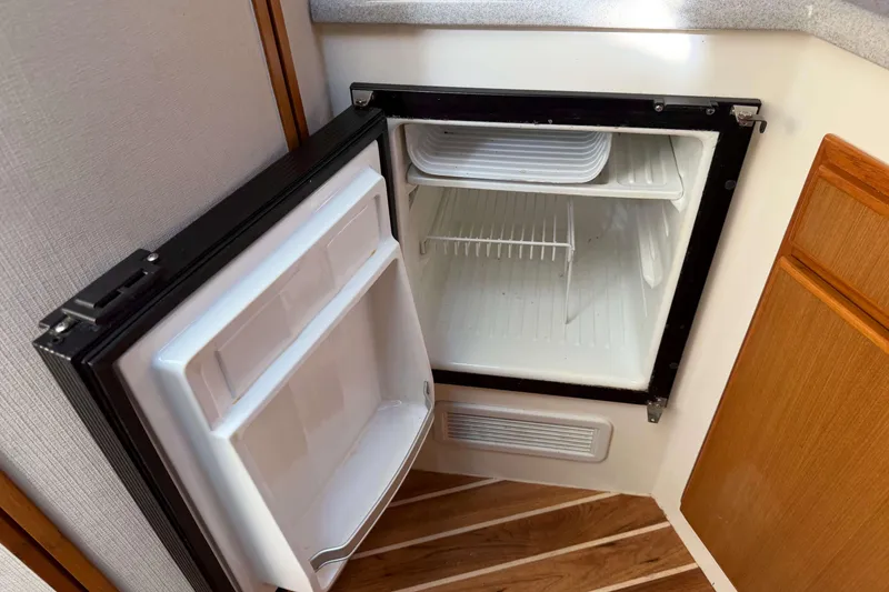 Slide: The Image of Open refrigerator inside 2008 Henriques 30 Express boat cabin. - 58