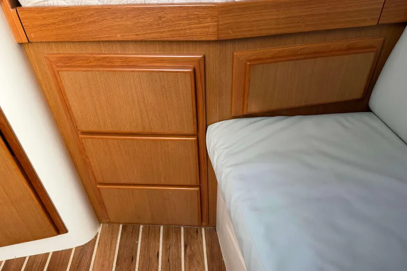 Slide: The Image of Interior of 2008 Henriques 30 Express boat with wooden cabinetry and cushioned seating. - 60